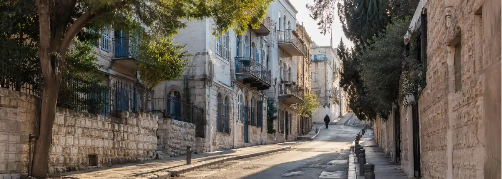 A rising street in central Jerusalem with layered stone buildings